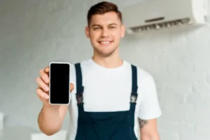 HVAC technician servicing an outdoor AC unit after a Facebook ad booking
