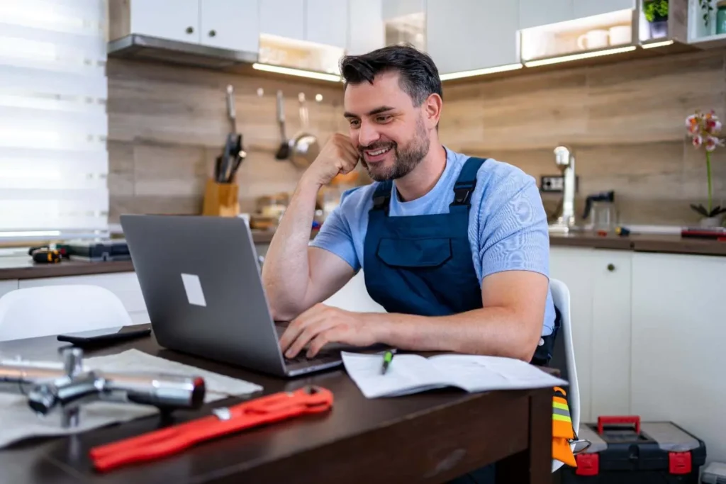 HVAC business owner reviewing paid advertising cost per lead data on laptop